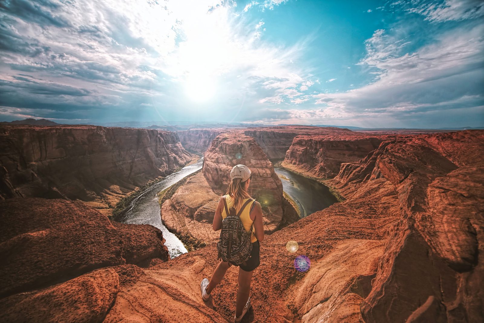 girl on edge of Grand Canyon overlooking Colorado river